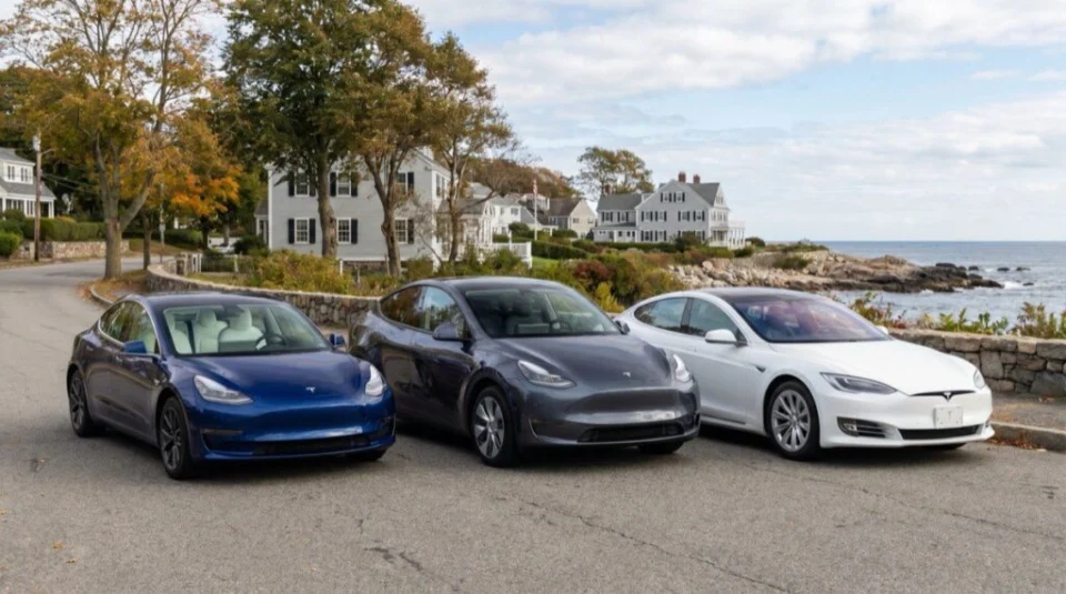 Three Tesla cars parked near a coastal neighborhood